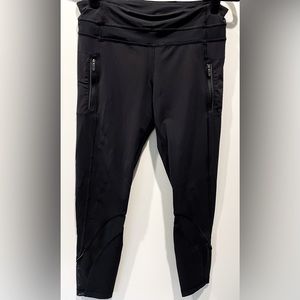 Lululemon Athletica black leggings with mesh details and zipper pockets